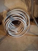 Full view of coiled light grey hose