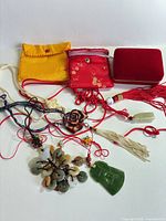 Lot overview showing all pendants, tassels and pouches