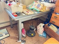 Full view of metal desk showing top, legs and surroundings