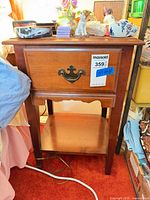 front view of wood nightstand showing drawer, pull, shelf