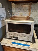 Front view of Panasonic toaster oven showing controls and overall condition