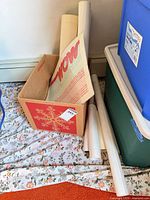 Rolled posters and prints stored in holiday box with additional poster tubes
