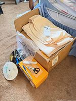 Box with folded fabric pieces, organizer, tin of notions