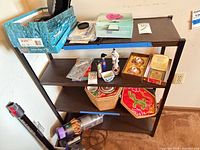 Front view of metal frame shelving unit with four laminate shelves; other items shown not included