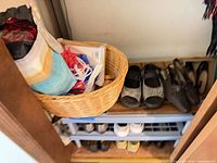 Overall rack showing multiple pairs of shoes and basket