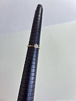 Ring on mandrel showing band and stone