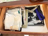Drawer with folded linens showing variety of fabrics and colors