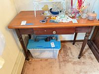 Front view of rectangular wooden table showing drawer, legs and surface