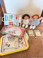 Overall lot showing dolls, trays, doctor kit, watch, play money