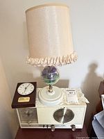Radio, lamp, and clock together showing overall lot contents