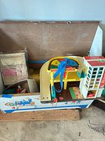 Overall view of toy box with Service Station and School House inside
