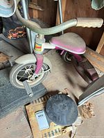 Full view of Murray tricycle and black rubber discus on shed floor
