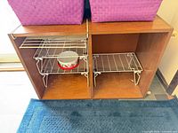 front view showing two open cubbies with wire racks inside