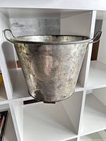 Full view of metal bread mixing pot on shelf