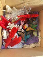Box containing multicolored feather birds