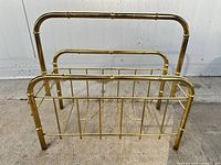 Front view of brass magazine rack showing overall structure