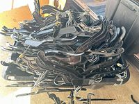 Pile of black plastic clothes hangers on bin