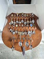 Front view of shield rack holding all souvenir spoons