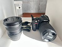 Nikon D3300 camera with attached 18-55 mm lens and additional aspherical lens