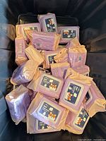 Bin containing many lavender and peach packs of pet wipes