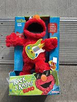 Front view of Rock & Rhyme Elmo plush in original packaging