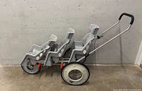 Full side view of three-seat Runabout stroller showing overall design and condition