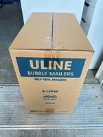 Front view of sealed Uline bubble mailers case displaying model, size, and quantity