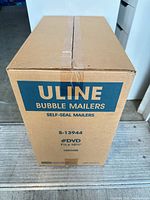Front view of sealed Uline S-13944 bubble mailer case showing model, size, and quantity details
