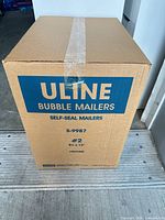 Front view of sealed Uline case showing label with product details