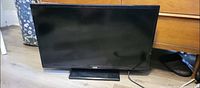 Front view of 30" RCA flat screen television with stand