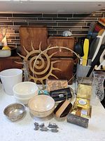 Group shot of entire lot on countertop showing wood boxes, ceramic pieces, glass decanter, metal items and sun wall décor