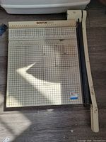 Full view of Boston 2655 paper cutter showing grid base and cutting arm
