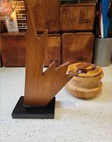 Abstract wood sculpture and segmented wood lidded bowl on countertop