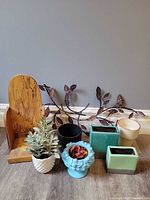 Group shot of all items including planters, wall vine, bookend, faux plants