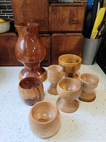 Group shot of all nine turned wooden pieces