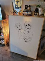 Front view of large whiteboard with wood frame and marker drawings