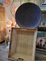 Rectangular tan wicker basket and dark brown round woven basket displayed upright