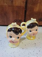 Front view of both child head shakers