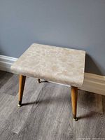 Full view of stool showing laminate top and legs