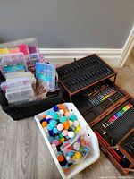 Overview of art case, pom poms bin and basket of bead organizers