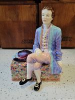 Front view of figurine showing full pose, colors and attire