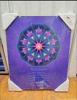 Front view showing artwork, shrink wrap, foam corners