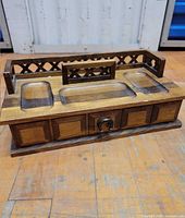 Top view of carved wood valet with lattice back and side rails
