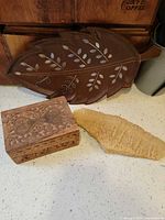 All three items together: carved box, leaf tray, crystal