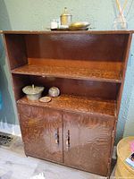 Full view of cabinet showing open shelves and lower cabinet doors
