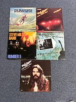Group shot of 5 vinyl record album jackets