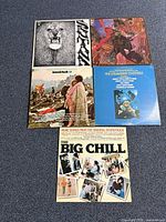 Five vinyl albums laid out on carpet