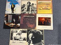 All eight album covers laid out