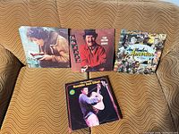 All four LP albums displayed on couch