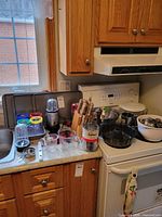 Countertop view showing bakeware sheets, Magic Bullet, knife block, mixing bowls, Bundt pan and accessories